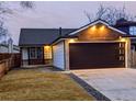 Charming home featuring a modern garage door, updated finishes, and inviting curb appeal at 11304 Elm Dr, Thornton, CO 80233