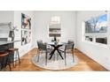 Bright dining area featuring modern table and chairs, complemented by unique artwork at 2038 Meade St, Denver, CO 80211