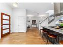 Open-concept living area with hardwood floors, white walls, and modern staircase at 2038 Meade St, Denver, CO 80211