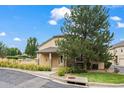 Inviting townhome showcasing a charming entrance, stone accents, and a well-maintained lawn at 3795 W 104Th Dr # E, Westminster, CO 80031