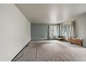 Bright living room featuring expansive carpeted space with good natural light and potential for creative redesign at 7917 Chase Cir # 160, Arvada, CO 80003