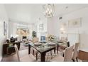 Elegant dining room with glass table, seating for six, and a decorative light fixture at 2700 E Cherry Creek South Dr # 216, Denver, CO 80209