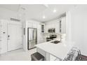Well-lit kitchen with stainless steel appliances, sleek white cabinets, and a breakfast bar at 2700 E Cherry Creek South Dr # 216, Denver, CO 80209