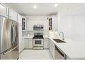 Bright kitchen with stainless steel appliances, white cabinets, and quartz countertops at 2700 E Cherry Creek South Dr # 216, Denver, CO 80209