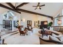 Spacious living room featuring high ceilings, exposed beams, and designer furnishings at 4856 Cheyenne Dr, Larkspur, CO 80118