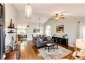 Spacious living room featuring hardwood floors, vaulted ceilings, and an open layout at 9846 Spring Hill Ln, Highlands Ranch, CO 80129