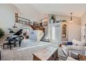 Spacious living room with high ceilings, a grand piano, and ample natural light at 7395 Slate Ct, Castle Rock, CO 80108