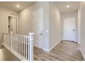 Bright hallway featuring wood-look floors and white doors with modern hardware at 14136 Bunny Hop Ln, Parker, CO 80134