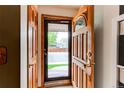 View of the home's entry featuring a wood door with decorative glass and a storm door at 10154 W Hawaii Pl, Lakewood, CO 80232