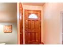 Welcoming foyer featuring a beautiful wooden door with decorative glass and neutral-toned walls at 10154 W Hawaii Pl, Lakewood, CO 80232