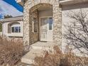 Inviting front entrance with stone accents and a decorative door at 671 Stafford Cir, Castle Rock, CO 80104