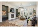 Inviting living room with a cozy fireplace, modern lighting, and stylish decor at 16392 Spanish Peak Way, Broomfield, CO 80023