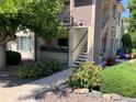 Attractive building exterior with a beautiful garden and walkway leading to the entrance at 5455 S Dover S St # 102, Littleton, CO 80123