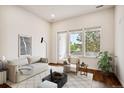 Comfortable living room with large windows, neutral colors and wood floors at 485 Interlocken Blvd # 102, Broomfield, CO 80021