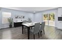 Bright dining area featuring modern furnishings, stylish decor, and sliding glass doors to the backyard at 1963 Hogan Ct, Castle Rock, CO 80109