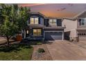 Charming two-story home with a well-maintained lawn, two-car garage, and covered front porch at 1963 Hogan Ct, Castle Rock, CO 80109