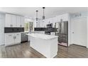 Modern kitchen with stainless steel appliances, a center island, and black backsplash at 1963 Hogan Ct, Castle Rock, CO 80109