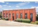 Brick building featuring multiple stories with well-maintained landscaping around the base at 3225 Blake St # 6, Denver, CO 80205