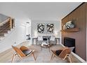Bright living room featuring modern furnishings, striking artwork, and a cozy fireplace, perfect for relaxing and entertaining at 5667 S Lowell Blvd, Littleton, CO 80123