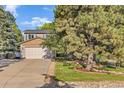Beautiful home with a two-car garage, mature trees, and a well-groomed lawn on a sunny day at 5506 Irish Pat Murphy Dr, Parker, CO 80134