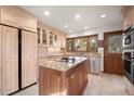 Well-lit kitchen with granite countertops, stainless steel appliances, and wooden island at 29089 Western Ln, Evergreen, CO 80439