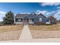 Inviting two-story home featuring a covered front porch, blue siding, and mature landscaping at 5372 Lenox Ct, Castle Rock, CO 80104