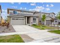 Charming two-story home with grey exterior, neat landscaping, and a concrete driveway at 24717 E 40Th Ave, Aurora, CO 80019