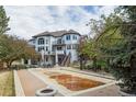 Beautiful backyard with a covered pool, an outdoor seating and eating area, a pergola and lovely landscaping at 9479 S Shadow Hill Cir, Lone Tree, CO 80124