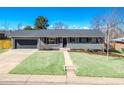 Beautifully updated home with attached garage, and manicured lawn boasts inviting curb appeal in a Gathering-friendly neighborhood at 3461 S Ivy Way, Denver, CO 80222