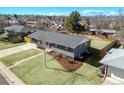 Charming single-story home boasts a well-manicured lawn, modern gray exterior, and a new roof, perfect for suburban living at 3461 S Ivy Way, Denver, CO 80222