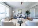 Bright living room with hardwood floors, contemporary furniture, and a large window at 3461 S Ivy Way, Denver, CO 80222