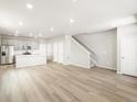 Bright open floor plan between kitchen and living room with stairs at 765 N Tibet St, Aurora, CO 80018