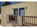 Exterior balcony view of the unit showing the balcony with wood railings and building exterior with two exterior doors at 2711 Mapleton Ave # 27, Boulder, CO 80304