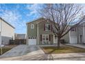 Charming two-story home with red shutters, a front yard, and a single-car garage at 1424 Swan Ave, Brighton, CO 80601