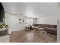 Spacious living room with modern floors, lots of sunlight, and a sectional sofa at 1424 Swan Ave, Brighton, CO 80601