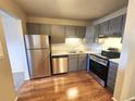 Modern kitchen featuring stainless steel appliances and wood flooring at 234 S Brentwood St # 105, Lakewood, CO 80226
