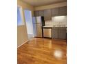 Bright kitchen boasts stainless steel appliances and wood floors at 234 S Brentwood St # 105, Lakewood, CO 80226