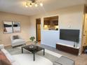 Inviting living room with cozy seating, a modern coffee table, and a view into the kitchen at 234 S Brentwood St # 105, Lakewood, CO 80226