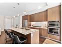 Modern kitchen with stainless steel appliances, granite counters, and a large island at 4200 W 17Th Ave # 211, Denver, CO 80204
