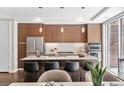 Modern kitchen features stainless steel appliances, granite counters, and sleek wood cabinetry at 4200 W 17Th Ave # 211, Denver, CO 80204