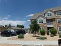 Charming apartment building with a mix of stone and siding, surrounded by well-kept landscaping and parking at 1851 S Dunkirk St # 201, Aurora, CO 80017