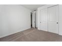 Clean, carpeted bedroom with a closet, fresh paint, and ample space for furniture at 25283 E Warren Pl, Aurora, CO 80018