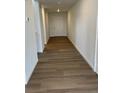 Inviting hallway with beautiful wood-look flooring leads to the front door, creating a warm and welcoming entrance at 3909 N Shawnee St, Aurora, CO 80019