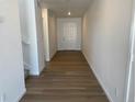 Inviting hallway with wood flooring and a clear view of the front door at 3909 N Shawnee St, Aurora, CO 80019