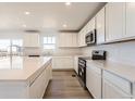 Open kitchen showcasing an island, stainless steel appliances, and ample counter space for cooking at 3909 N Shawnee St, Aurora, CO 80019