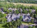 An aerial view captures a charming neighborhood nestled among lush greenery and mature trees at 2770 S Elmira St # 42, Denver, CO 80231