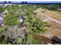Overhead capture shows a beautiful stream meandering through a green neighborhood near walking paths at 2770 S Elmira St # 42, Denver, CO 80231