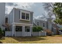 Charming two-story townhouse featuring grey siding, white trim, and a well-manicured front yard at 2770 S Elmira St # 42, Denver, CO 80231