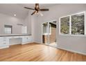 Bright bedroom with vaulted ceilings, hardwood floors, built-in desk and a sliding door to the outside at 5463 Rockhampton Cir, Highlands Ranch, CO 80130