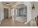 Bright foyer with hardwood floors, statement lighting, and floor to ceiling glass at 4121 Mesa Top Dr, Monument, CO 80132